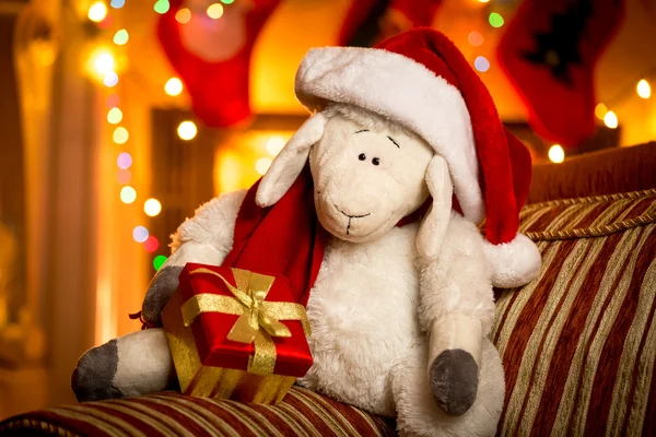 Toy sheep with gift box at decorated for Christmas living room — Stock Photo, Image