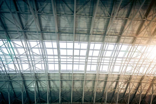 Metal roof at urban terminal with sun shining through windows — Stock Photo, Image