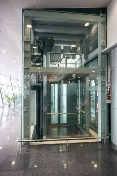 Glass elevator at airport terminal — Stock Photo, Image