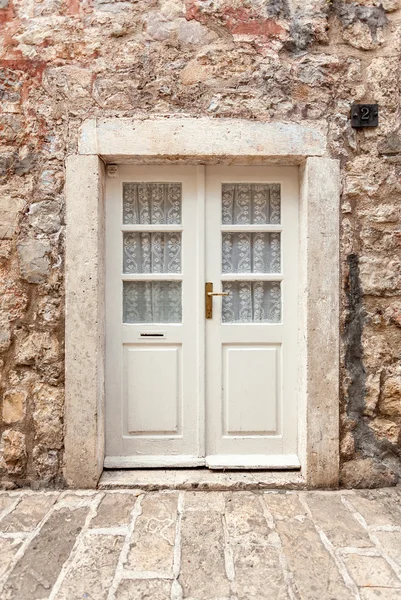 White classic door in ancient stone building — Stock Photo, Image