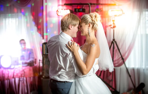 Newly married couple dancing at colorful lights and flares — Stock Photo, Image