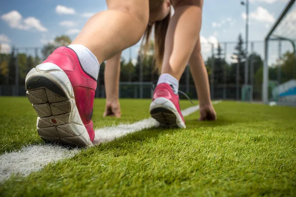 Woman runner feet on start line on grass — Stock Photo, Image