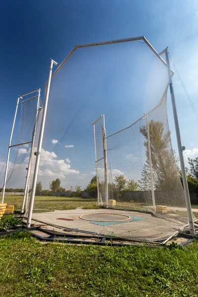 Arena for throwing hammer surrounded by safety net — Stock Photo, Image