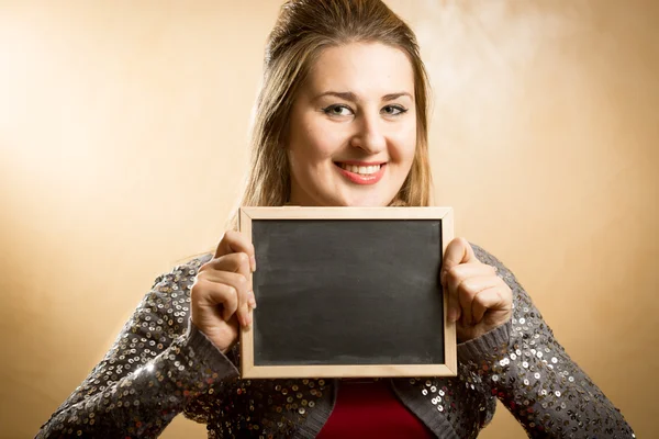 Cute woman posing with black chalkboard — Stock Photo, Image