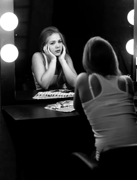 Monochorme portrait of sad woman looking at reflection in mirror — Stock Photo, Image