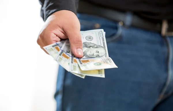 Man showing hand with hundred dollar banknotes — Stock Photo, Image