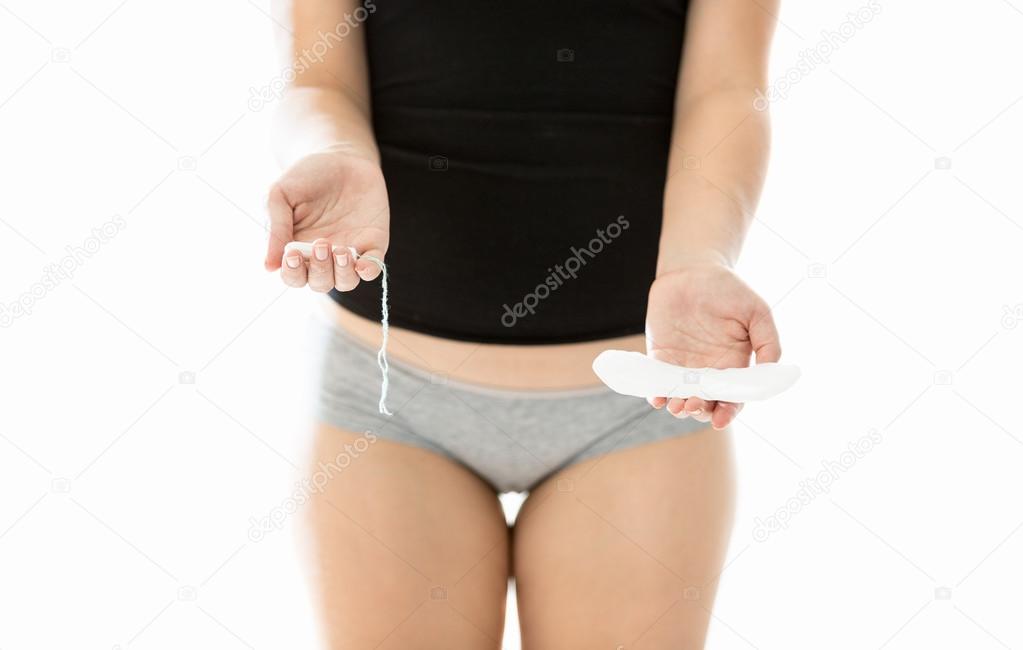 woman choosing between tampon and pad