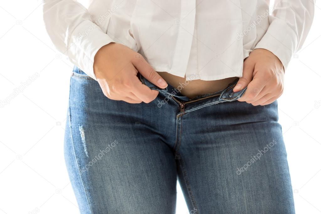 sexy slim woman putting on blue jeans