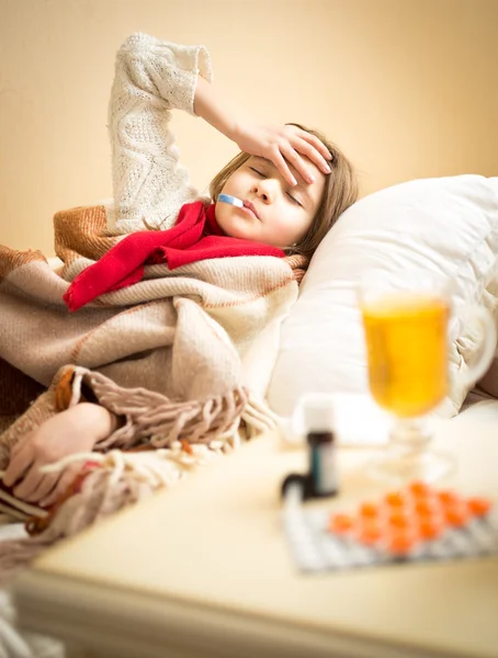 Little girl measuring temperature and suffering of headache — Stock Photo, Image