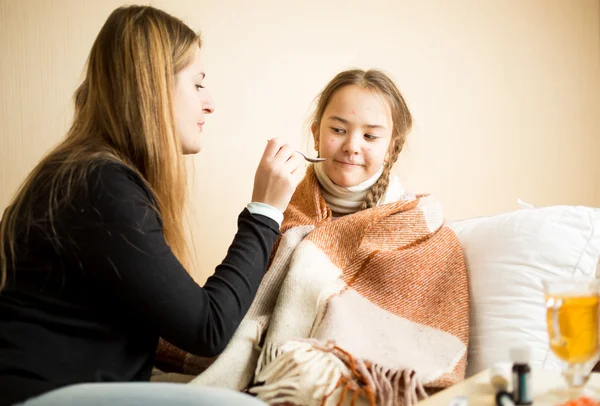 Little girl refusing drinking medicines given by mother — Stock Photo, Image