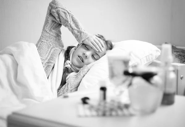 Monochrome portrait of little sick girl lying at bed — Stock Photo, Image