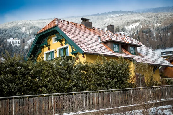 Dřevěný dům v Alpách proti vysoké hory — Stock fotografie