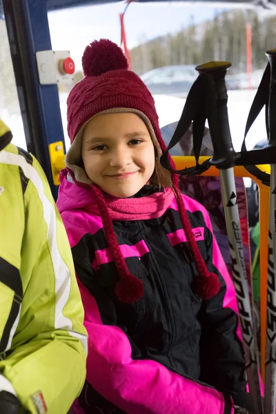 Portrait of cute smiling girl with ski sticks — Stock Photo, Image