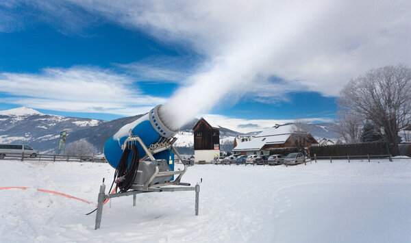 artificial snow on ski resort at cold day in Alps