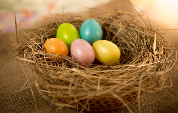 Easter eggs lying on table at nest — Stock Photo, Image