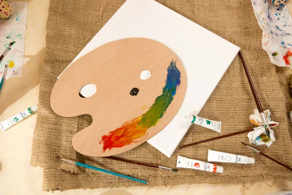 Professional artist tools and paints lying on table at studio — Stock Photo, Image