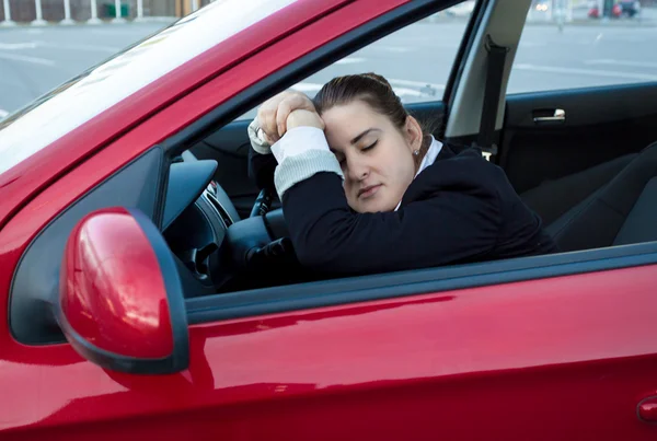 Woman sleeping in car on drivers seat — Stock Photo, Image