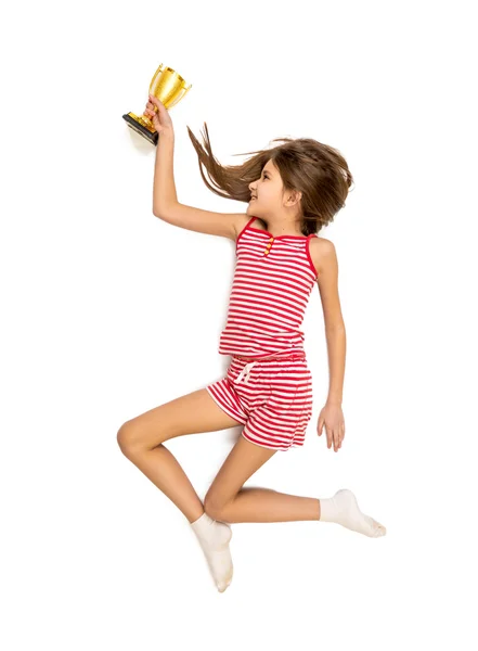 Foto isolada de menina feliz correndo com copo de troféu dourado — Fotografia de Stock