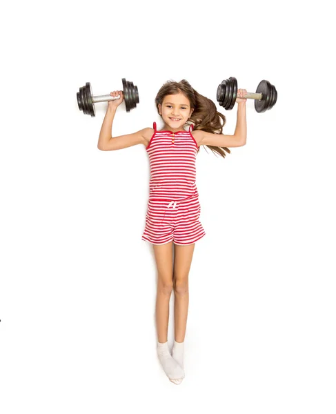 High point view of girl lying on floor and doing exercise with d — Stock Photo, Image