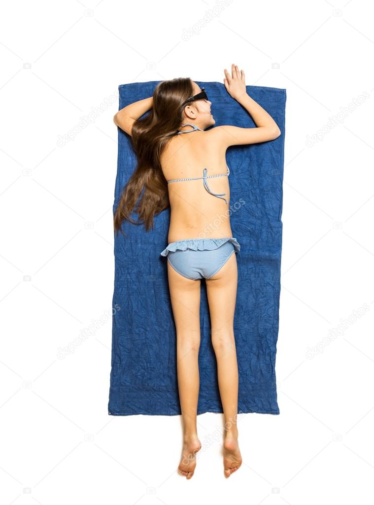 Isolated photo from top of cute girl sunbathing on blue towel