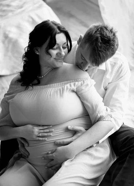 Closeup portrait of elegant man kissing pregnant wife at shoulde — Stock Photo, Image