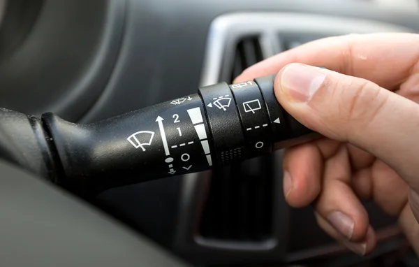 Macro shot of driver adjusting windscreen wipers control toggle — Stock Photo, Image