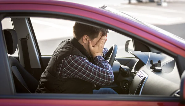 Portrait of shocked male driver closing face with hands — Stock Photo, Image
