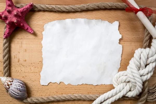 Empty piece of paper with border of ropes, knots and seashells — Stock Photo, Image