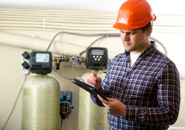 Inspector checking work of factory equipment — Stock Photo, Image