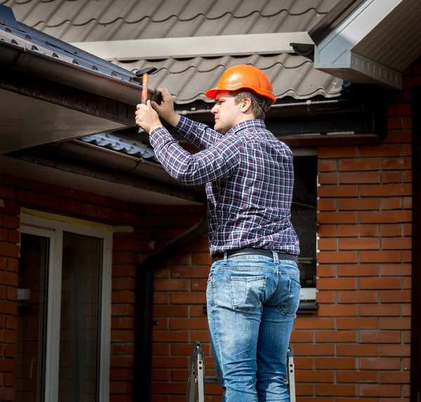 Carpenter hammering roof boards with hammer — Stock Image Carpenter hammering roof boards with hammer Stock Photo