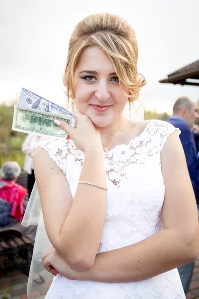 Retrato de hermosa novia sosteniendo paquete de dinero —  Fotos de Stock