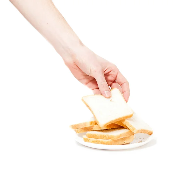 Male hand tacking piece of bread for toasts — Stock Photo, Image