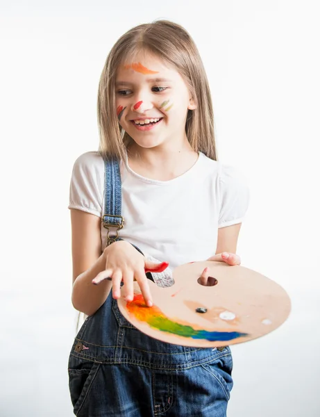Portrait of girl painted by different colors posing at studio — Stock Photo, Image