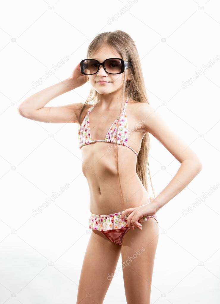 Portrait of cute little girl in swimming suit and sunglasses