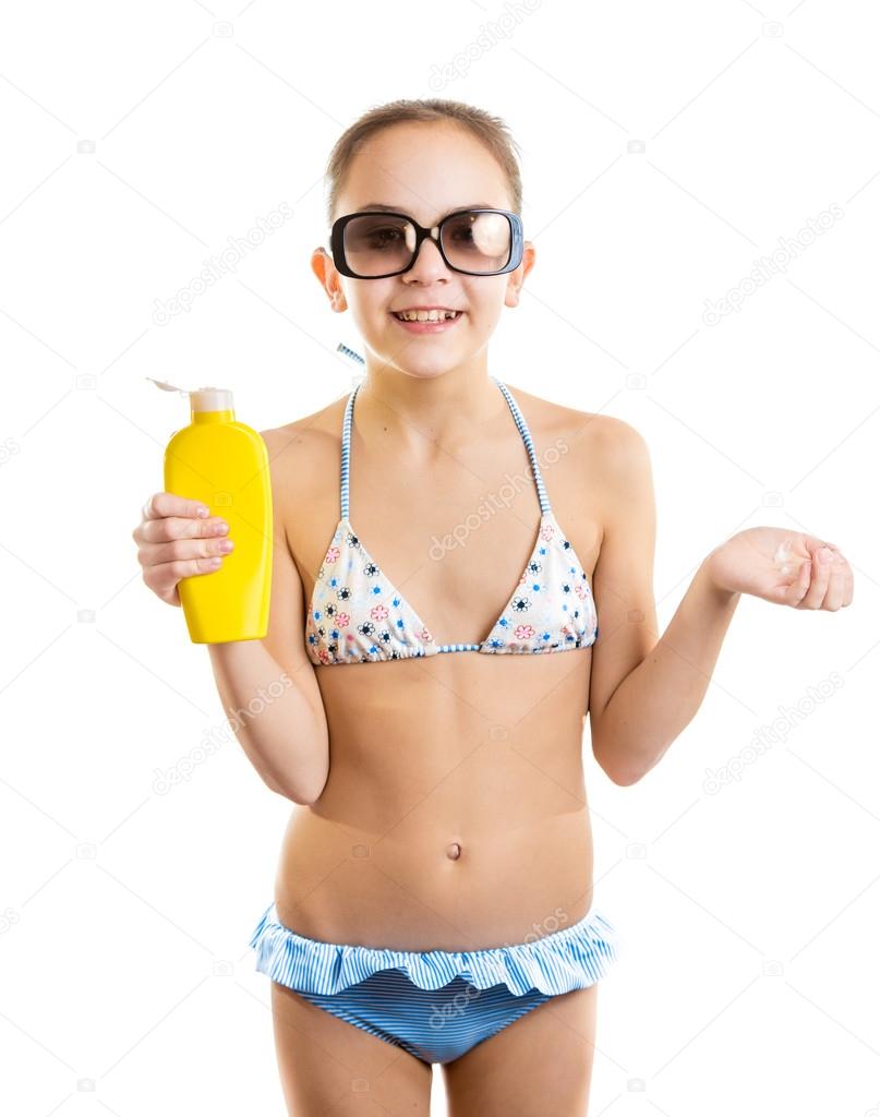 smiling girl in sunglasses holding bottle of suntan lotion