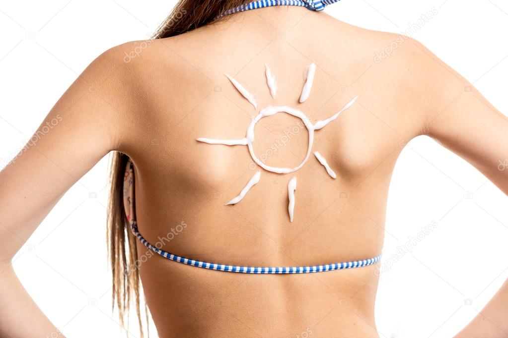 isolated shot of sun drawn by sun lotion on girls back