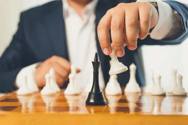 Toned photo of businessman making move with white pawn on chess — Stock Photo, Image