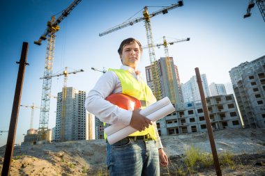 construction manager posing on building site at sunny day