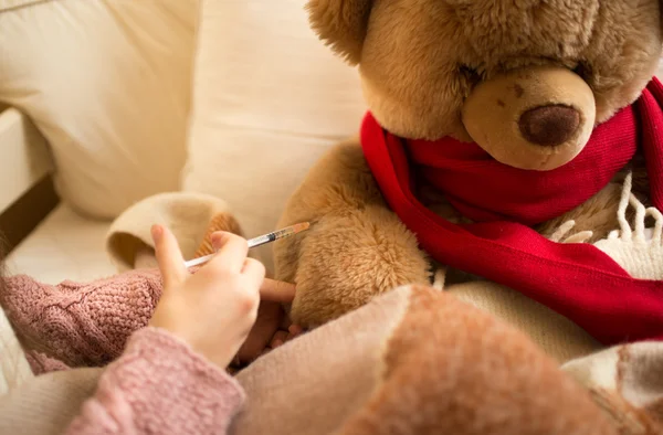 Closeup of little girl doing injection to sick teddy bear — Stok fotoğraf