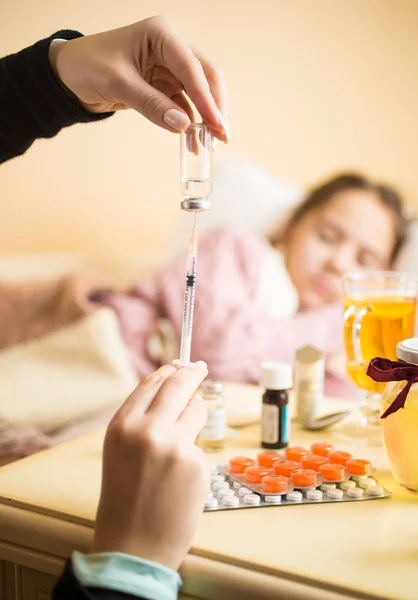 Closeup of mother filling syringe at children bedroom — Stok fotoğraf