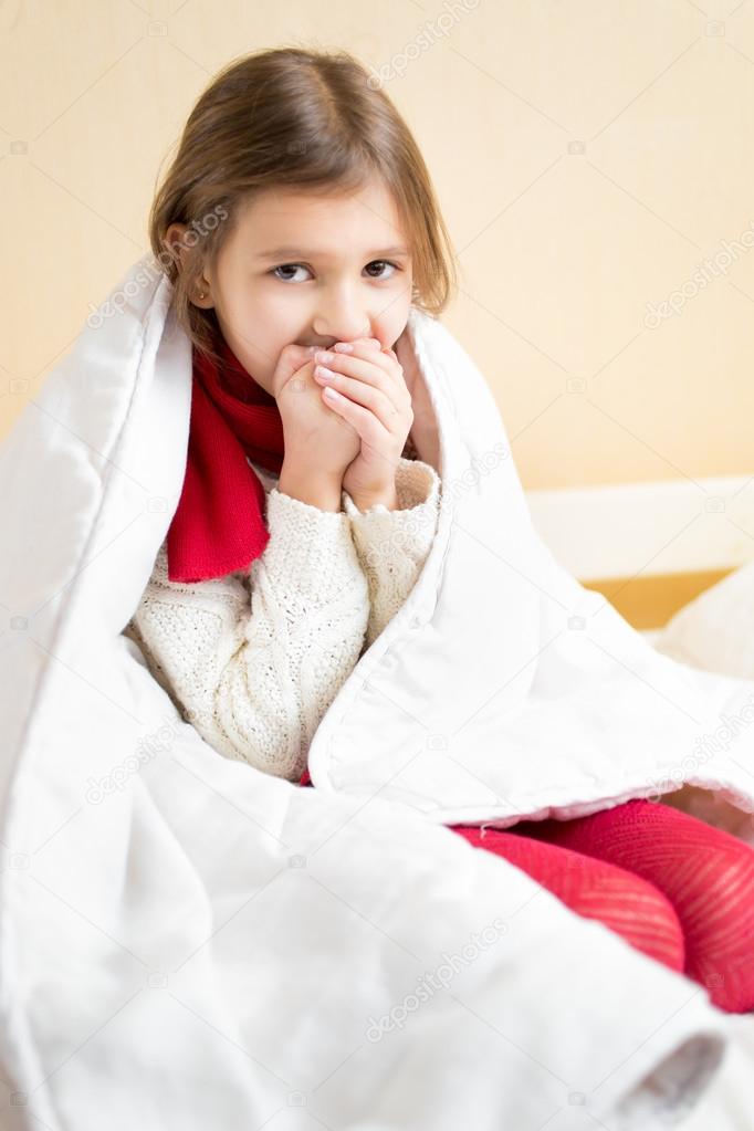 Girl wrapped in blanket Sick girl wrapped in blanket coughing in bed