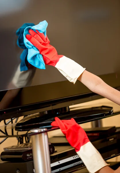 Primer plano de la mujer en guantes de goma de limpieza de pantalla de TV con trapo — Foto de Stock