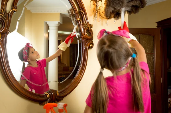 거울과 램프 브러시로 청소 하는 귀여운 여자 — 스톡 사진