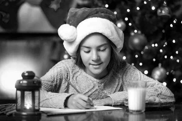 Portrait of cute girl writing letter to Santa Claus at living ro — Stock Photo, Image