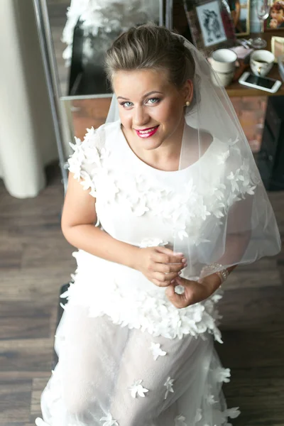 Sensual bride in white lace wedding dress posing at home — Stock Photo, Image