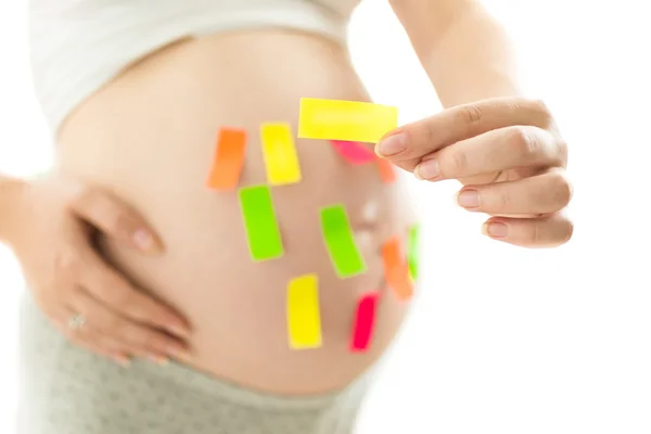 Изолированное фото беременной женщины с красочными наклейками — стоковое фото