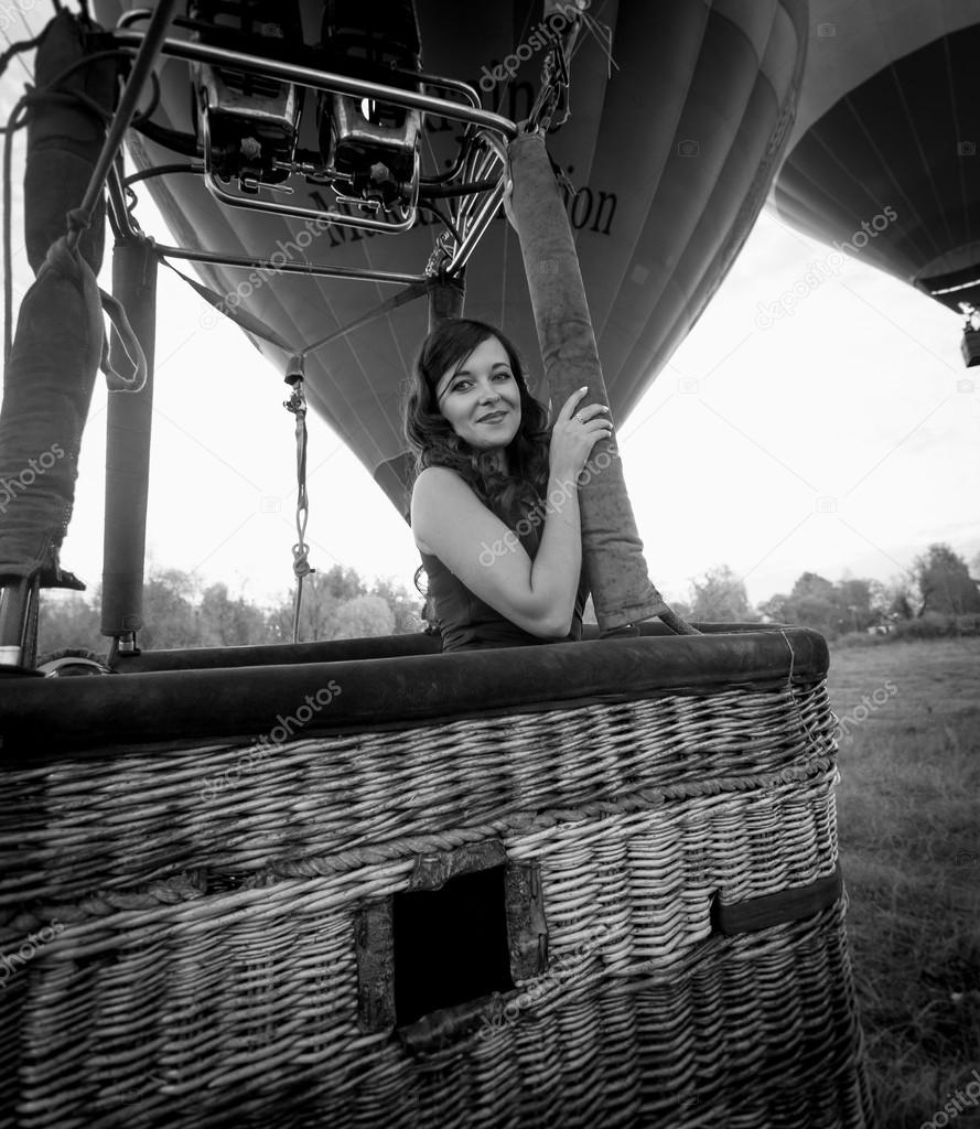 portrait of beautiful sexy woman posing at hot air balloon baske