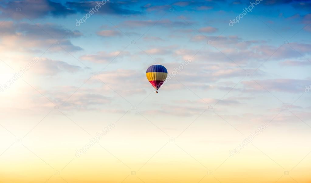 Beautiful colorful hot air balloon floating in the sky at sunrise
