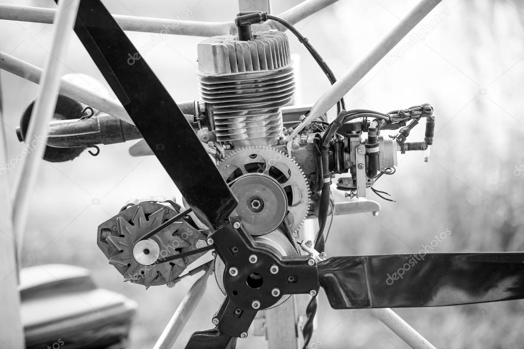 black and white photo of paraglider engine and propeller