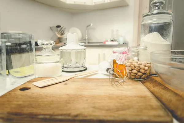 Toned shot of utensils and ingredients for baking on table at ki — Stock Photo, Image